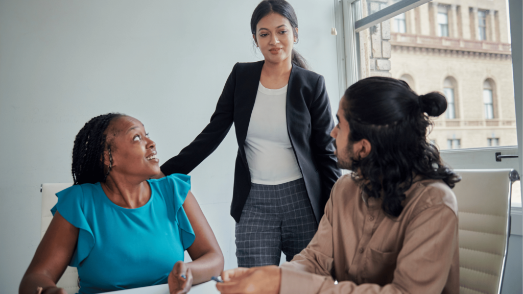 Group of sales professionals brainstorming strategies during a team meeting in the conference room